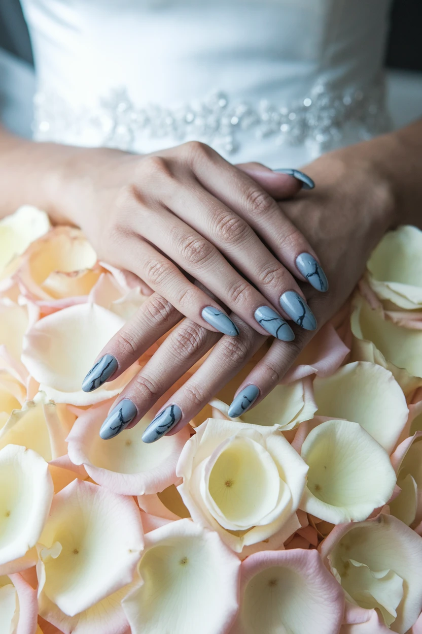 Blue nails with black marble swirls.