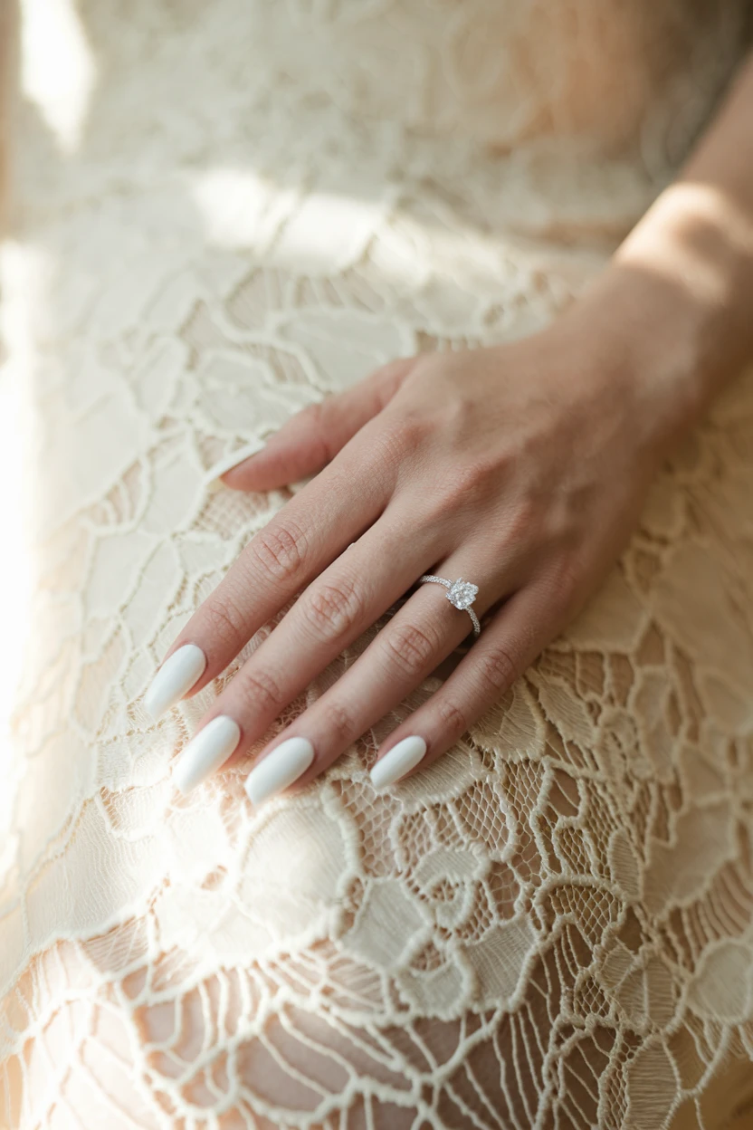 White nails, diamond ring, lace dress.