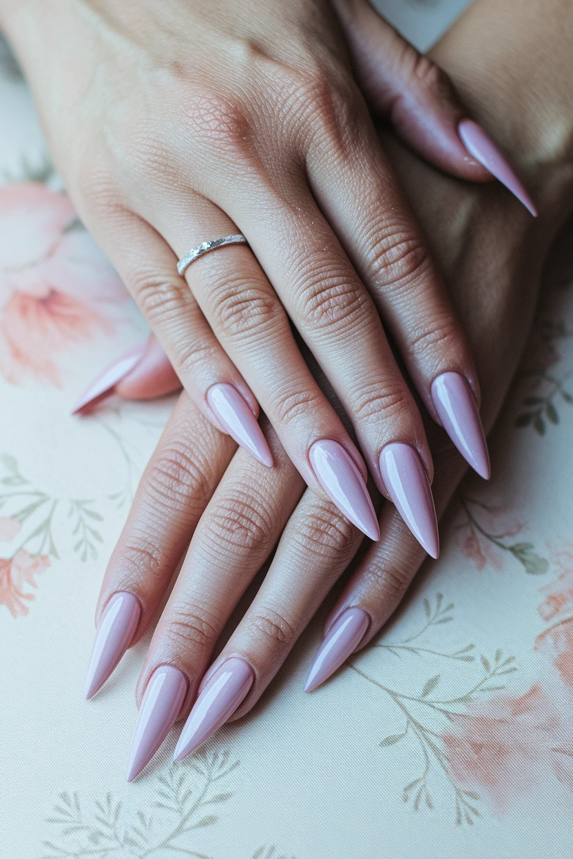 Lavender stiletto nails with silver ring.