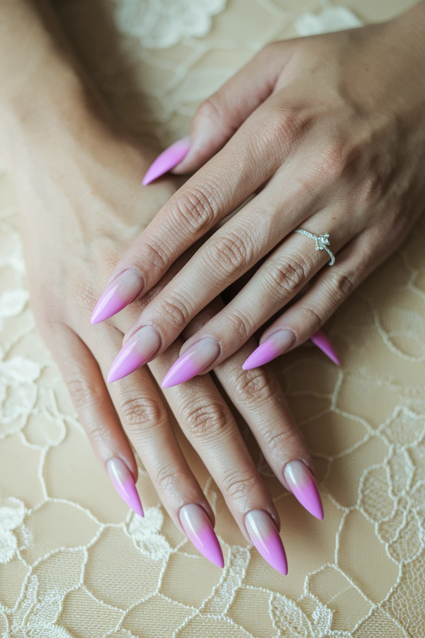 Pink ombre stiletto nails with silver ring.